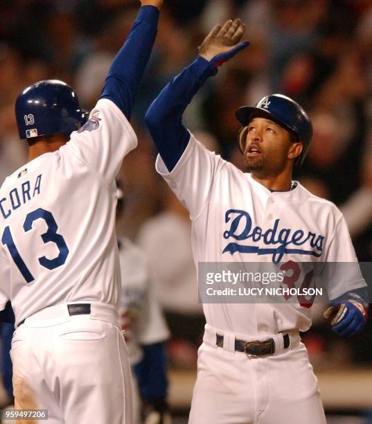 Los Angeles Dodgers' Dave Roberts and Alex Cora celebrate after they scored off Brian Jordan's go-ahead grand slam against the San Fransisco Giants...