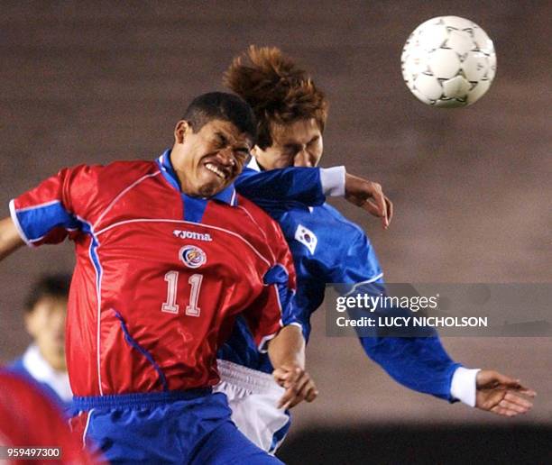 Ronald Gomez of Costa Rica heads the ball against Tae-Young Kim of South Korea during first half action at their semi-final of the Gold Cup in...