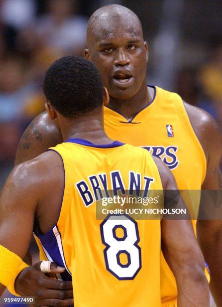 Los Angeles Lakers' Shaquille O'Neal congratulates teammate Kobe Bryant for scoring against the Portland Trail Blazers in the final quarter of Game 1...