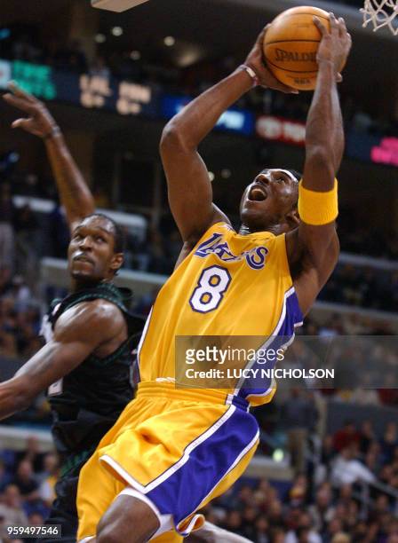 Los Angeles Lakers' Kobe Bryant drives past Minnesota Timberwolves' Joe Smith to score in the second quarter at the Staples Center in Los Angeles, 01...