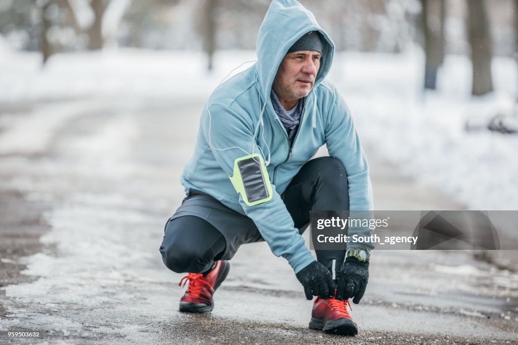 Runner tying shoelace in park