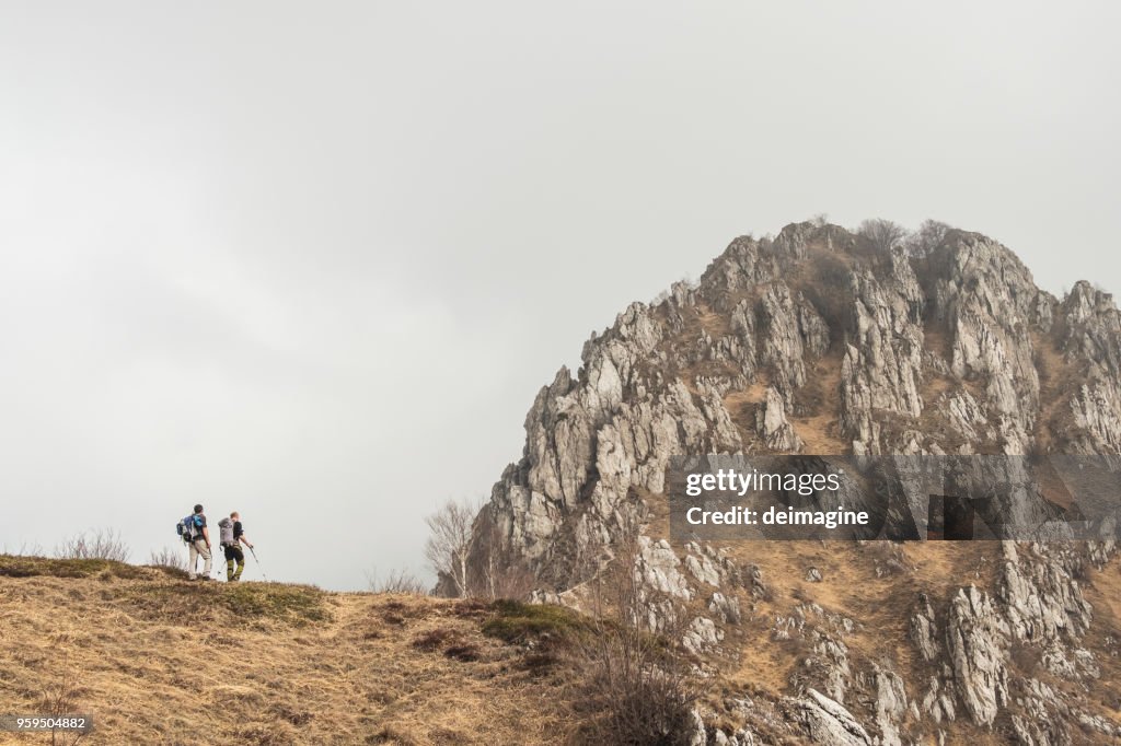 Hikers walking to mountains range