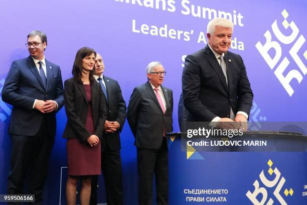 Montenegro's Prime Minister Dusko Markovic signs a document during a joint press conference during an EU-Western Balkans Summit in Sofia on May 17,...