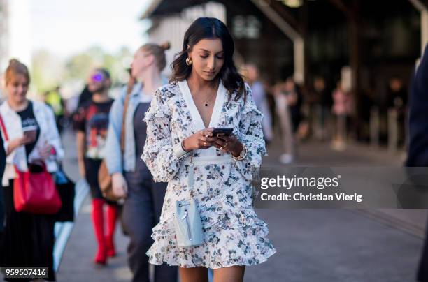 Guest wearing white dress with print during Mercedes-Benz Fashion Week Resort 19 Collections at Carriageworks on May 17, 2018 in Sydney, Australia.