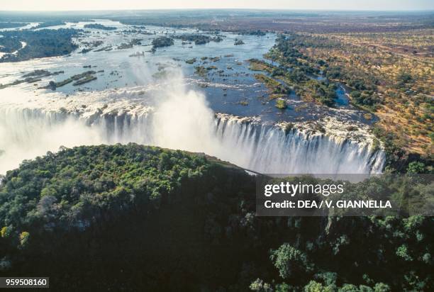 Aerial view of the Victoria Falls on the Zambezi River, Mosi-oa-Tunya National Park, Zambia, and Victoria Falls National Park, Zimbabwe.