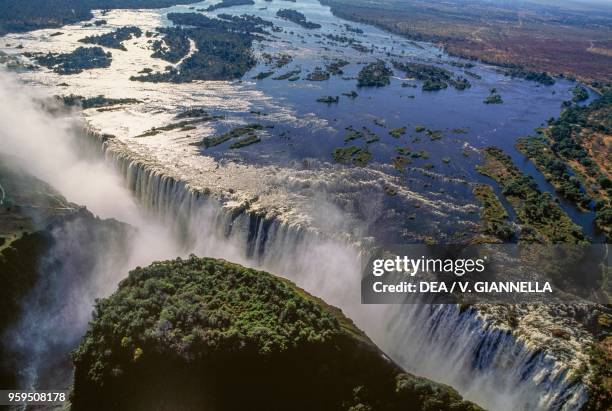 Aerial view of the Victoria Falls on the Zambezi River, Mosi-oa-Tunya National Park, Zambia, and Victoria Falls National Park, Zimbabwe.