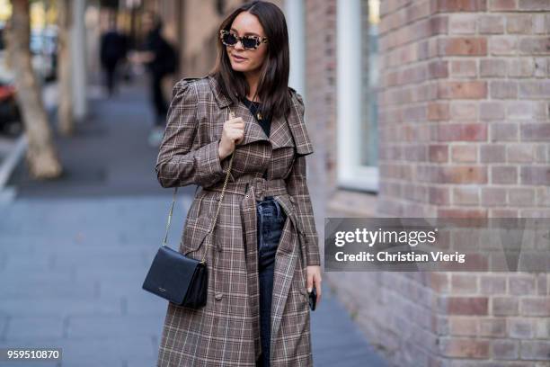 Guest wearing brown plaid coat, slingbacks, cropped denim jeans during Mercedes-Benz Fashion Week Resort 19 Collections at Carriageworks on May 17,...