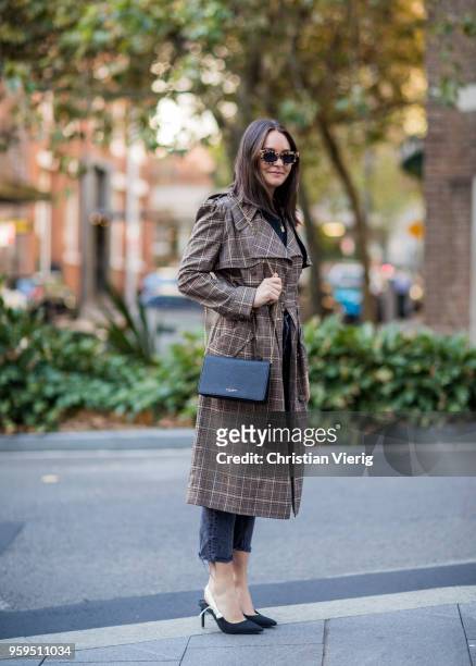 Guest wearing brown plaid coat, slingbacks, cropped denim jeans during Mercedes-Benz Fashion Week Resort 19 Collections at Carriageworks on May 17,...