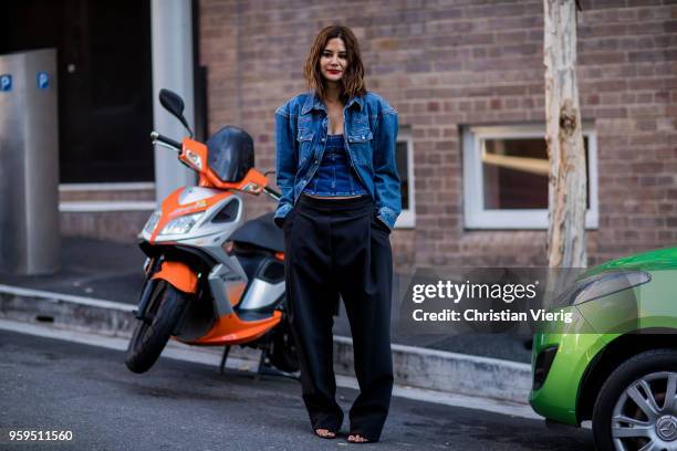 Christine Centenera wearing wide leg pants, denim jacket during Mercedes-Benz Fashion Week Resort 19 Collections at Carriageworks on May 17, 2018 in...