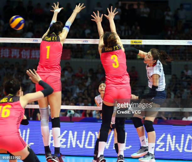 Xinyue Yuan and Fangxu Yang of China defend against Yeon Koung Kim of South Korea during the FIVB Volleyball Nations League 2018 at Beilun Gymnasium...