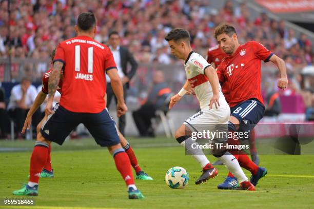 James Rodriguez of Muenchen, Erik Thommy of Stuttgart and Javi Martinez of Muenchen battle for the ball during the Bundesliga match between FC Bayern...