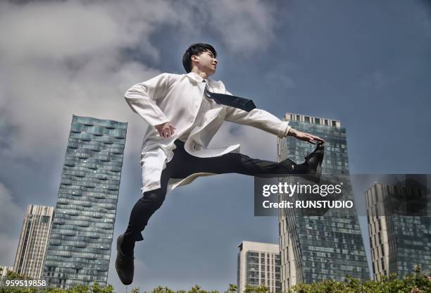 doctor jumping in city - doctor leaping stock pictures, royalty-free photos & images