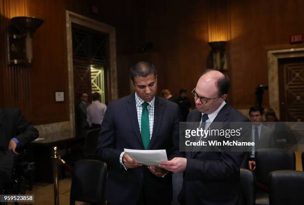 Chairman Ajit Pai confers with an aide prior to testimony before the Senate Appropriations Committee May 17, 2018 in Washington, DC. The committee...