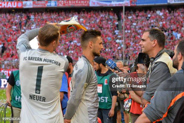 Goalkeeper Manuel Neuer of Muenchen showers Goalkeeper Sven Ulreich of Muenchen with beer after the Bundesliga match between FC Bayern Muenchen and...