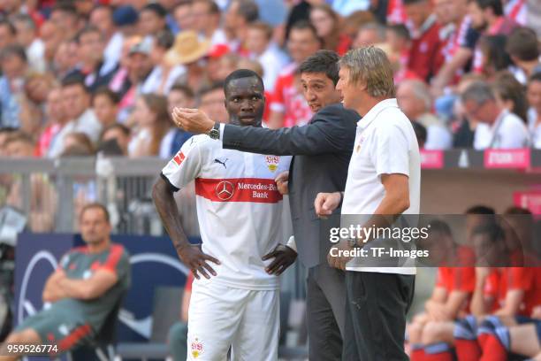 Chadrac Akolo of Stuttgart speaks with Head coach Tayfun Korkut of Stuttgart during the Bundesliga match between FC Bayern Muenchen and VfB Stuttgart...