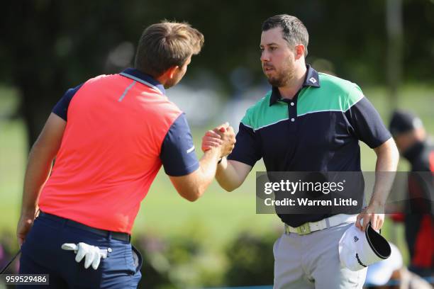 Ryan Evans of England shakes hands with Mathieu Decottignies-Lafon of France on the 9th green during the first round of the Belgian Knockout at the...