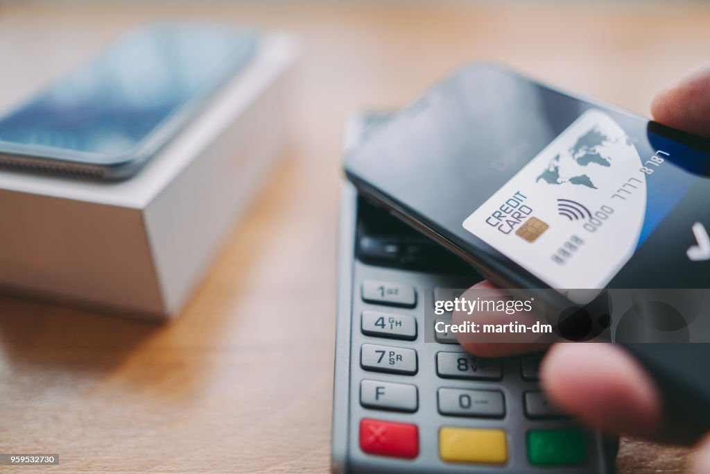 Man buying smartphone with digital wallet