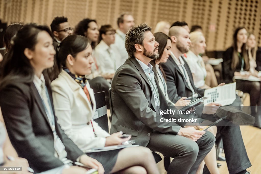 Business people in seminar at auditorium