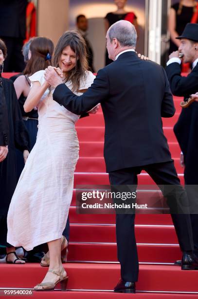 Cannes Film Festival President Pierre Lescure dances with a woman as musicians play on the red carpet before the screening of "Capharnaum" during the...