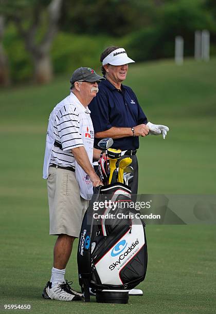 Peter Jacobsen talks over his yardage with caddie Mike "Fluff" Cowan on during the first round of the Mitsubishi Electric Championship at Hualalai...