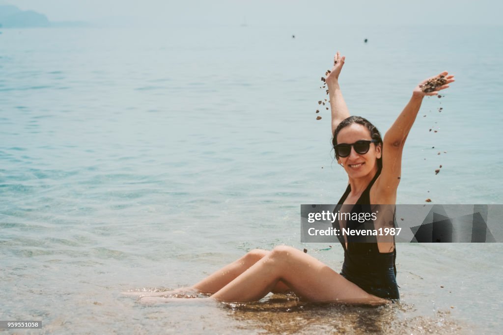 Excited Female with Raised Arms Goes Toward Wavy Sea