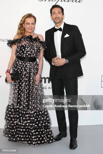 Caroline Scheufele and Adrien Brody arrive at the amfAR Gala Cannes 2018 at Hotel du Cap-Eden-Roc on May 17, 2018 in Cap d'Antibes, France.