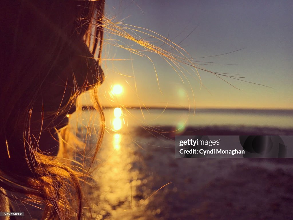 Girl with Windswept Hair at Sunset