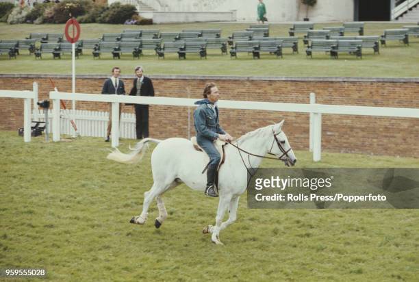 Antony Armstrong-Jones, 1st Earl of Snowdon rides a white horse during a race involving members of the British royal family during Royal Ascot race...