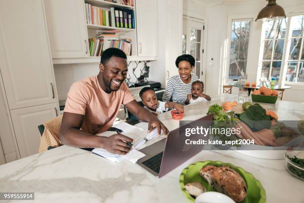 financial management - young family in kitchen stock pictures, royalty-free photos & images