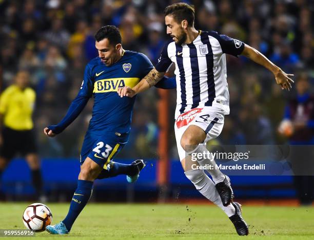 Carlos Tevez of Boca Juniors fights for the ball with Tomas Costa of Alianza Lima during a match between Boca Juniors and Alianza Lima at Alberto J....