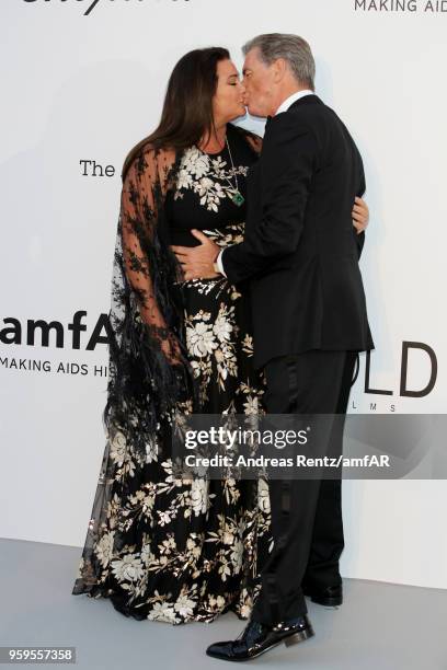 Pierce Brosnan and his wife Keely Shaye Smith share a kiss as they arrive at the amfAR Gala Cannes 2018 at Hotel du Cap-Eden-Roc on May 17, 2018 in...