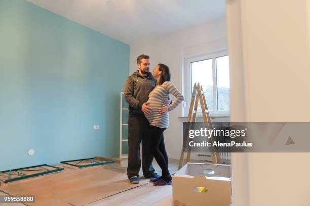 pregnant couple in a new home - young couple with baby stock pictures, royalty-free photos & images