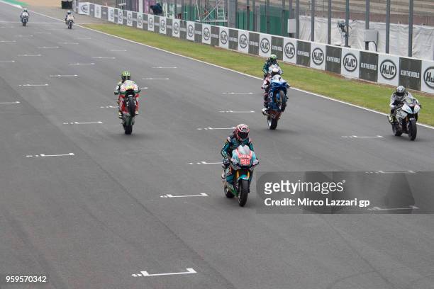 The Handy and MotoGP riders head down a straight during the pre-event "MotoGP riders meets the Handy Riders during the International Handy Racers"...