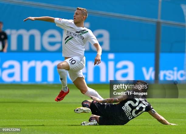 Sebastian Maier of Hannover and Charles Aranguiz of Leverkusen battle for the ball during the Bundesliga match between Bayer 04 Leverkusen and...