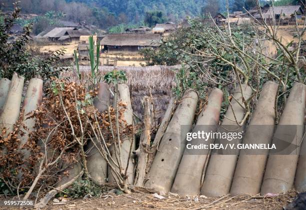 Ogives of American bombs used as a fence in the village of Sa La along the Ho Chi Minh Path, Laos.