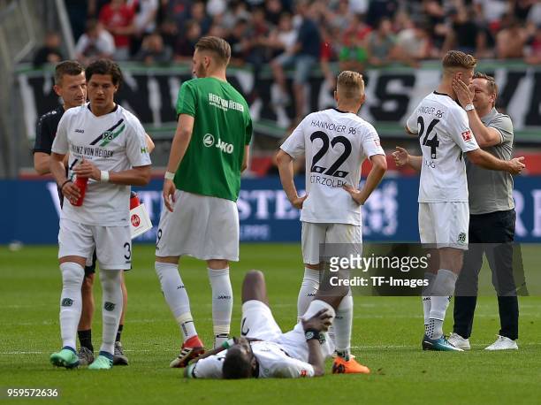 Sporting director Horst Heldt of Hannover and Niclas Fuellkrug of Hannover look on during the Bundesliga match between Bayer 04 Leverkusen and...