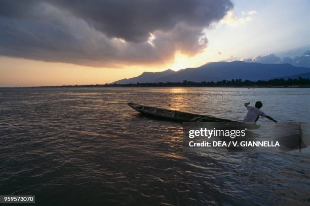 Boat at sunset on the Mekong River, between Pakse and Don Khong island, Laos.