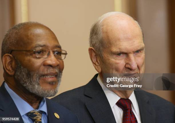 Dr. Amos C. Brown Chairman of Interfaith relations for the NAACP and President of the Mormon Church Russell M. Nelson listen at a press conference at...