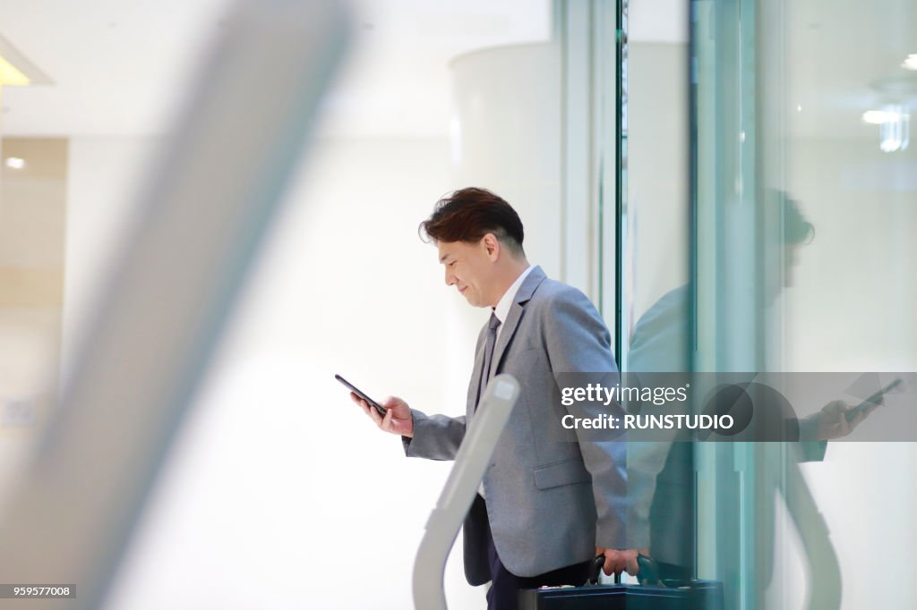 Middle aged businessman coming out of the elevator