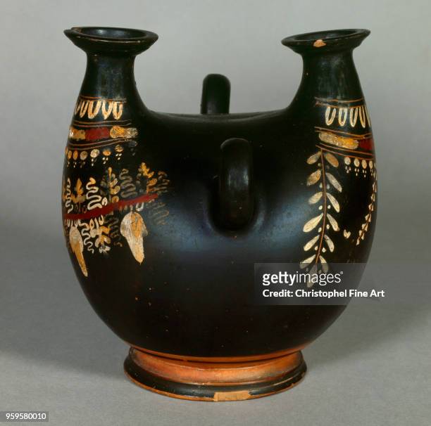 Askos of the Gnathia style has two vertical beaks with vegetal decor , Greek Art, Louvre Museum, Greece.