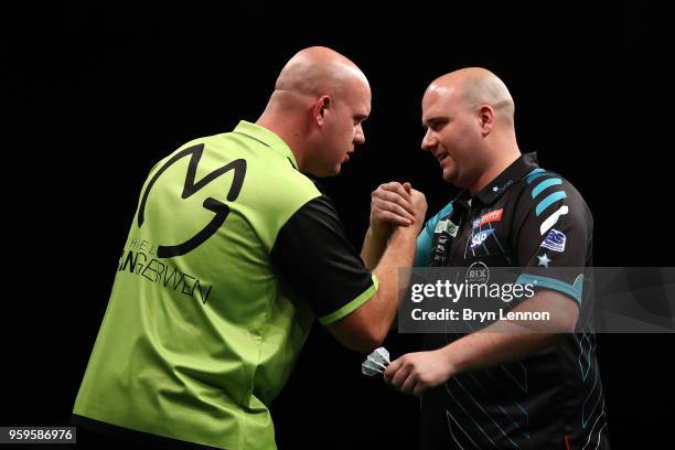 Michael van Gerwen of The Netherlands shakes hands with Rob Cross of Great Britain after winning their semi-final at the Betway Premier League Darts...