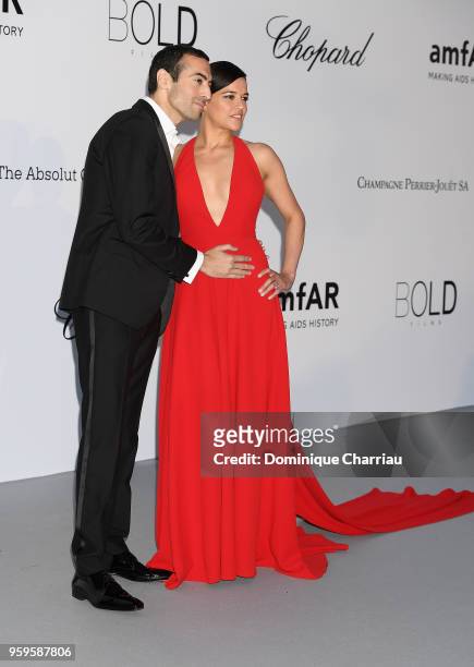 Mohammed Al Turki and Michelle Rodriguez arrive at the amfAR Gala Cannes 2018 at Hotel du Cap-Eden-Roc on May 17, 2018 in Cap d'Antibes, France.