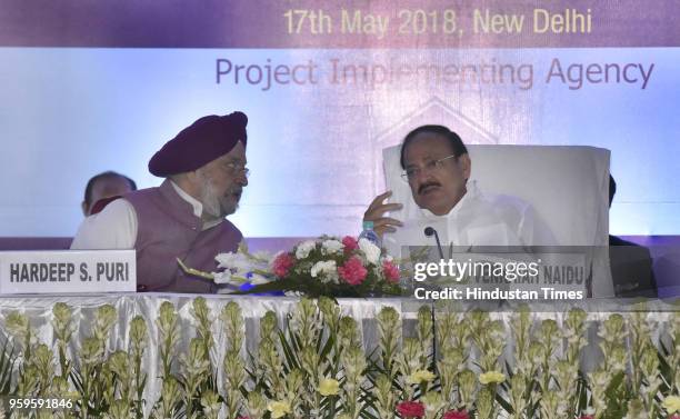 Vice President of India M. Venkaiah Naidu talks with Union Minister of State of Housing and Urban Affairs Hardeep Singh Puri, during the foundation...