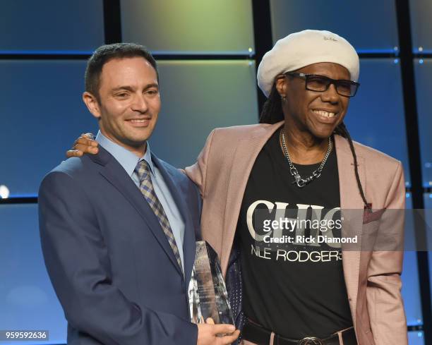 Chairman of Music Biz, Fred Beteille presents an award to Nile Rogers onstage during the Music Biz 2018 Awards Luncheon for the Music Business...