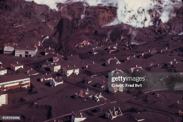 Volcano eruption on Heimaey Island in Iceland on 23 January 1973. Aerial view of the city of Vestmannaeyjar buried in lava and ashes.