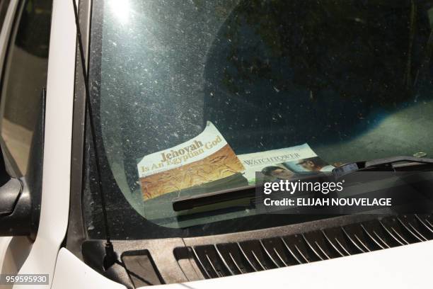 Religious items are seen on the dashboard of a vehicle parked in front of a home where ten children were allegedly tortured and abused on May 17 in...