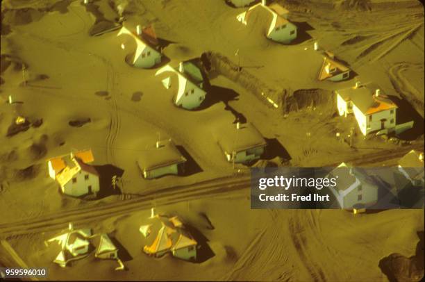 Volcano eruption on Heimaey Island in Iceland on 23 January 1973. Lava and ashes bury homes, barns and farmland. Aerial view.