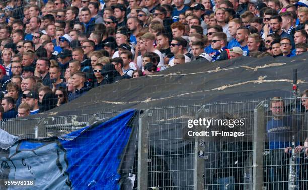 Ultras of Hamburg hide under a tarp during the Bundesliga match between Hamburger SV and Borussia Moenchengladbach at Volksparkstadion on May 12,...