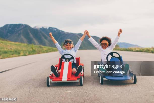 young team of business girls race go carts - business finish line stock pictures, royalty-free photos & images