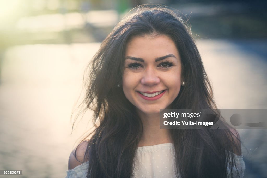 Smiling woman with long brunette hair